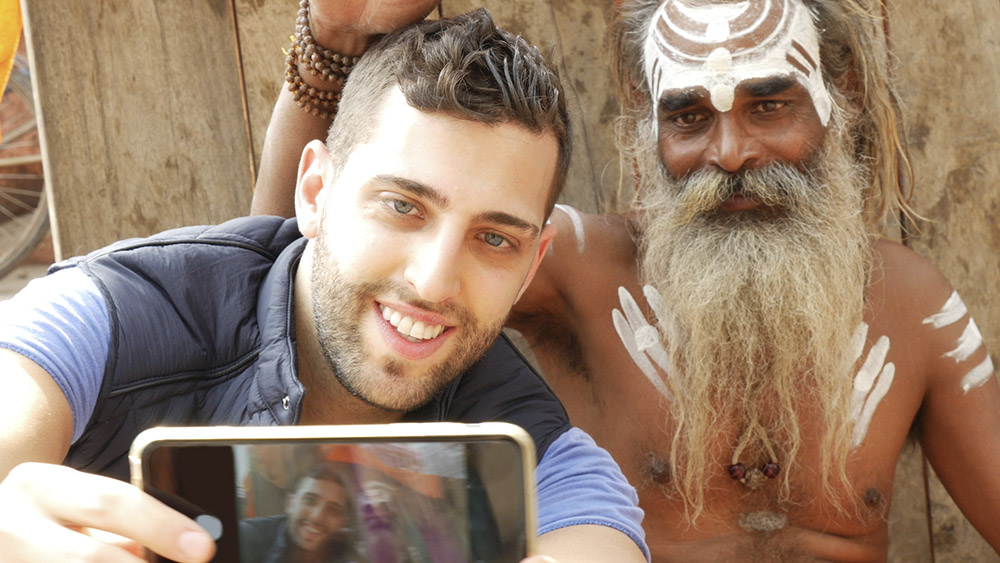 tourist taking a selfie with sadhu holy man, in varanasi, indi